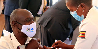 A health worker in Uganda receives a Covid-19 vaccine.