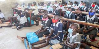 Kenyan primary school students attend class. 