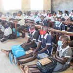 Kenyan primary school students attend class. 