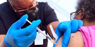 A nurse administers the Pfizer Covid-19 vaccine at a mobile vaccine clinic