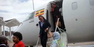 Passengers disembarking from a Uganda Airlines flight 