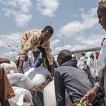 A youngster arranges food aid on a cart