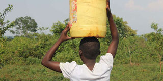 A girl carries water.