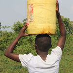 A girl carries water.
