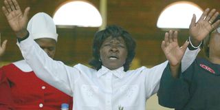 A woman raises her hands in prayer in Zimbabwe's capital Harare.