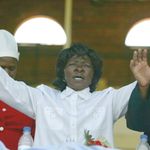 A woman raises her hands in prayer in Zimbabwe's capital Harare.