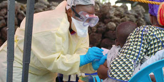 A child receives a vaccine against Ebola 