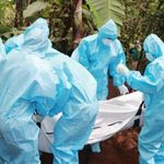 Kenyan public health officials bury a person who died of Covid-19.