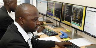 Stockbrokers monitor trade on Uganda Securities Exchange in Kampala.