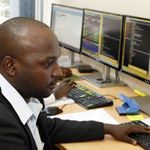 Stockbrokers monitor trade on Uganda Securities Exchange in Kampala.