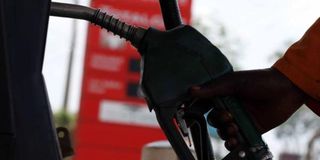 A petrol station attendant at a pump.