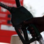 A petrol station attendant at a pump.