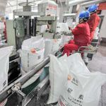 Workers seal sacks of Kunlun urea at a chemical fertiliser plant in China.