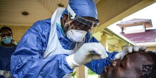 A medical worker takes samples for Covid-19 testing.