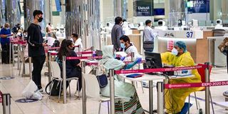 Tourists get a medical screening upon arrival at Teminal 3 at Dubai airport, in the United Arab Emirates, on July 8, 2020.