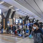 Travellers queue at a check-in counter at OR Tambo International Airport in Johannesburg on November 27, 2021.