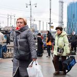 People walk near the Kyiv-Pasazhyrskyi railway station in Kyiv on February 24, 2022, following the Russian invasion.