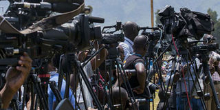 Journalists wait for an interview. 