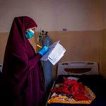 A nurse makes notes in a ward for severely malnourished babies.