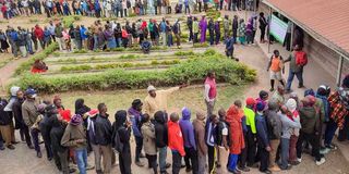 Voters wait to cast their votes at a polling station in Nairobi on August 9, 2022.