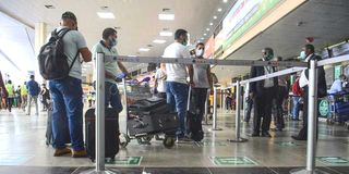 Passengers wait to check in at the Murtala Muhammed International Airport, Nigeria.