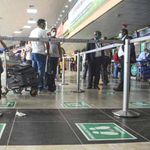 Passengers wait to check in at the Murtala Muhammed International Airport, Nigeria.