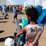Ethiopian refugees who fled the Tigray conflict gather to receive aid.