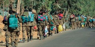 Ethiopian National Defense Force soldiers walk along a road on December 6, 2021.