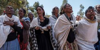 Women mourn victims of a massacre in Tigray.