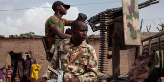 Nigerian soldiers patrol 