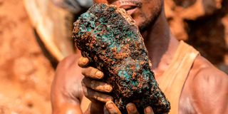 miner holds a cobalt stone at the Shabara mine 
