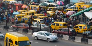 Commuters board mini buses in Lagos, Nigeria