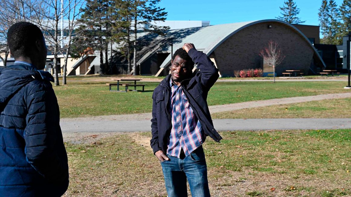 Serge Nouemssi speaks with another student in Canada