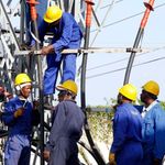 Kenya Power employees repairing a transformer.