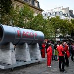 Activists next to a fake Eacop pipeline structure
