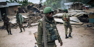 A soldier from the armed forces of the DRC on foot patrol in the village of Manzalaho near Beni. 