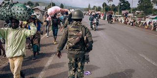 Congolese soldier walks in Kanyaruchinya, north of Goma 