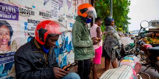 Motorcycle taxi riders using smartphones