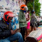 Motorcycle taxi riders using smartphones
