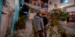 Iraqis stand at a renovated area in Mosul