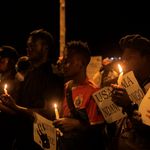 Residents hold candles as they gather in Beni, DR Congo