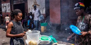 A man sells food at the Kihisi parking lot in Goma