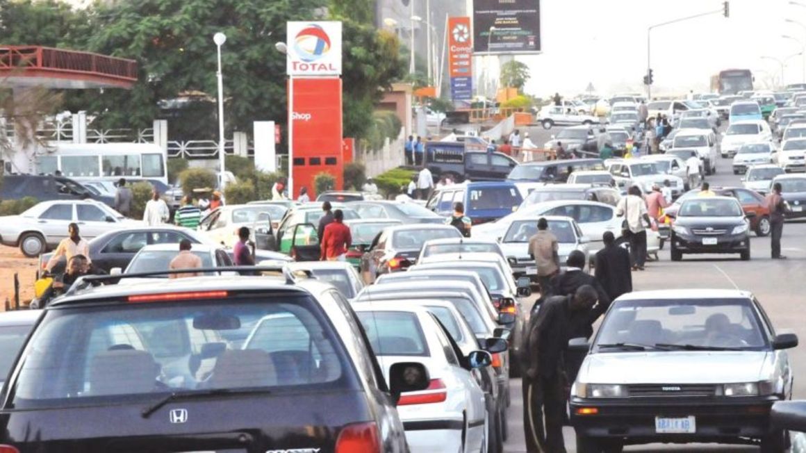 Motorists queue for petrol at a filling station in Nigeria