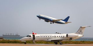 A plane flies from the Aden Abdulle International Airport in Somalia.