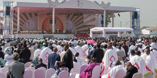 Faithful and clergy wait for Pope Francis to celebrate Mass