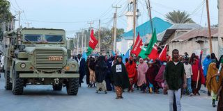 Demonstrators attend a rally against the Al-Shabaab