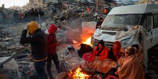 Survivors gather next to a bonfire in Kahramanmaras 