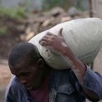 A man carrying a bag of cement.