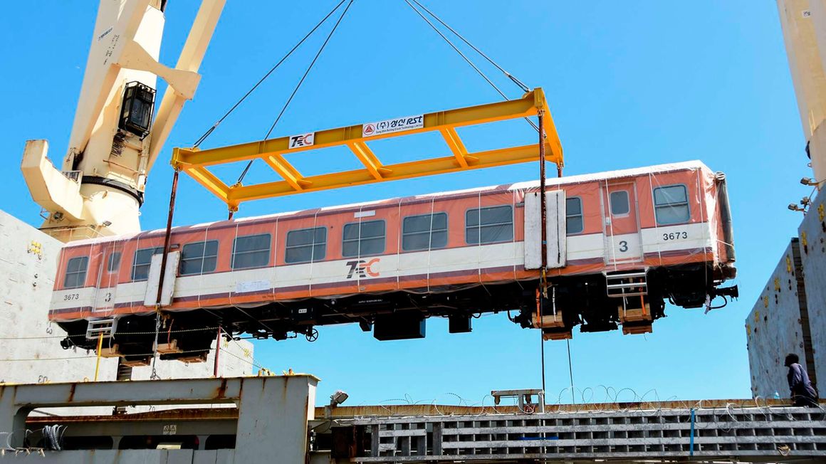 A carriage for the Tanzania SGR project is unloaded 