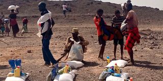 Residents of Kakiteitei village in Turkana, Kenya relief food